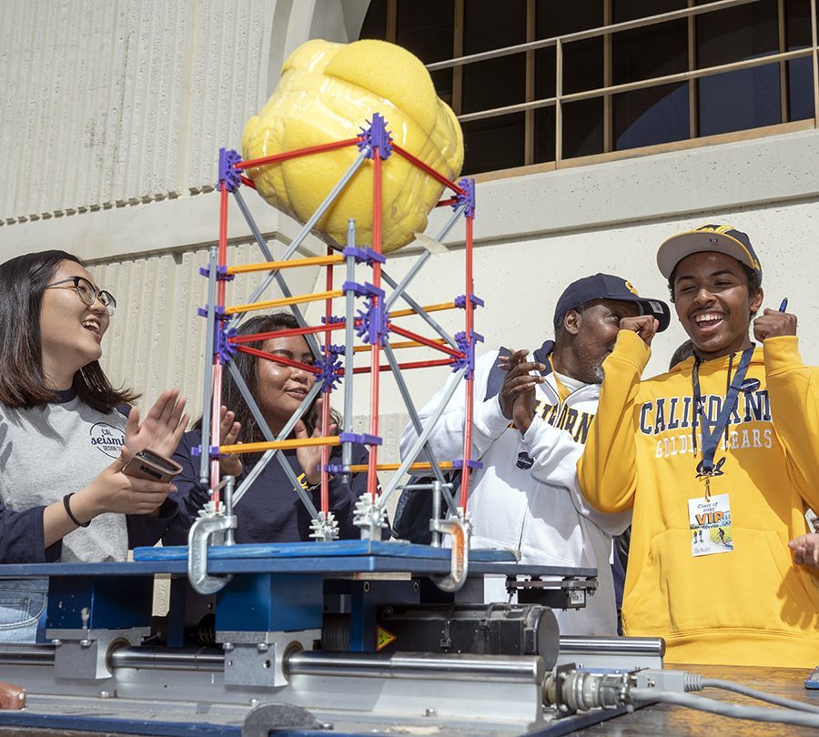 Photo of 4 students interacting at Cal Day event in 2019